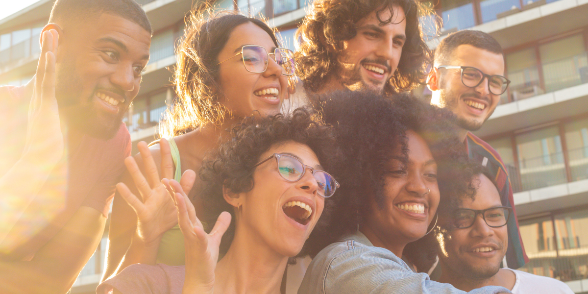 group of happy diverse people taking a selfie