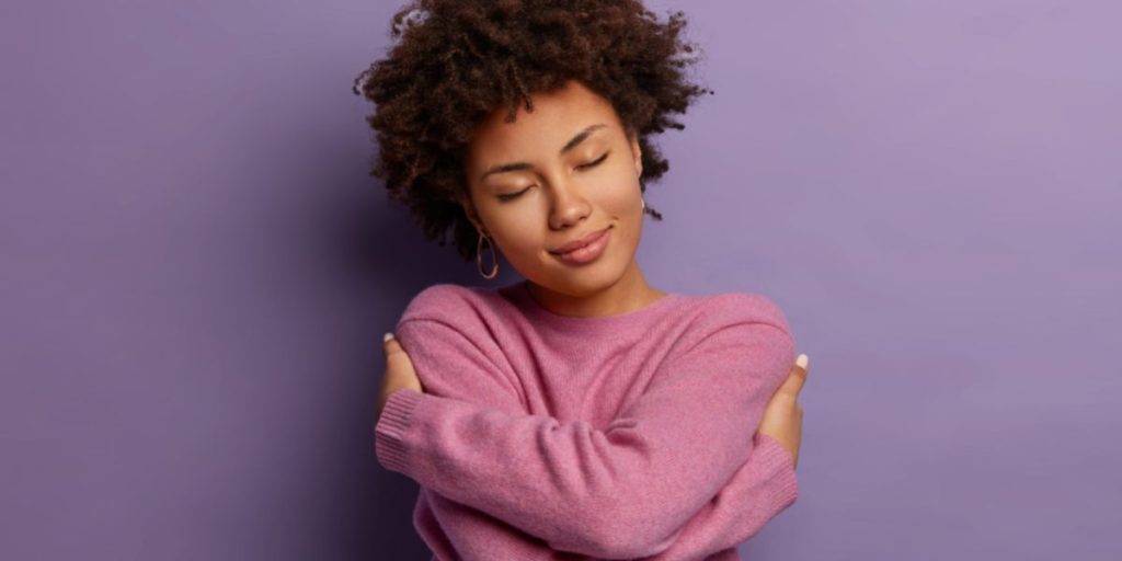 Woman hugging herself