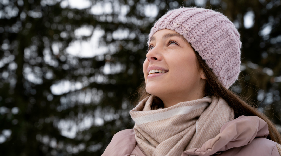 woman practicing self-care outside during winter