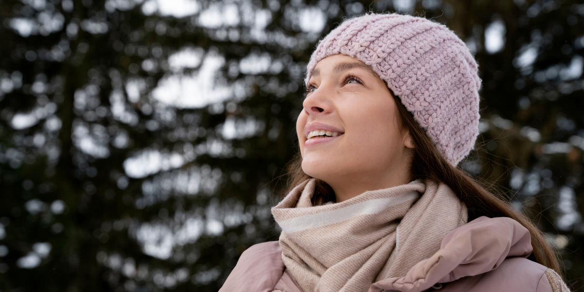 woman practicing self-care outside during winter