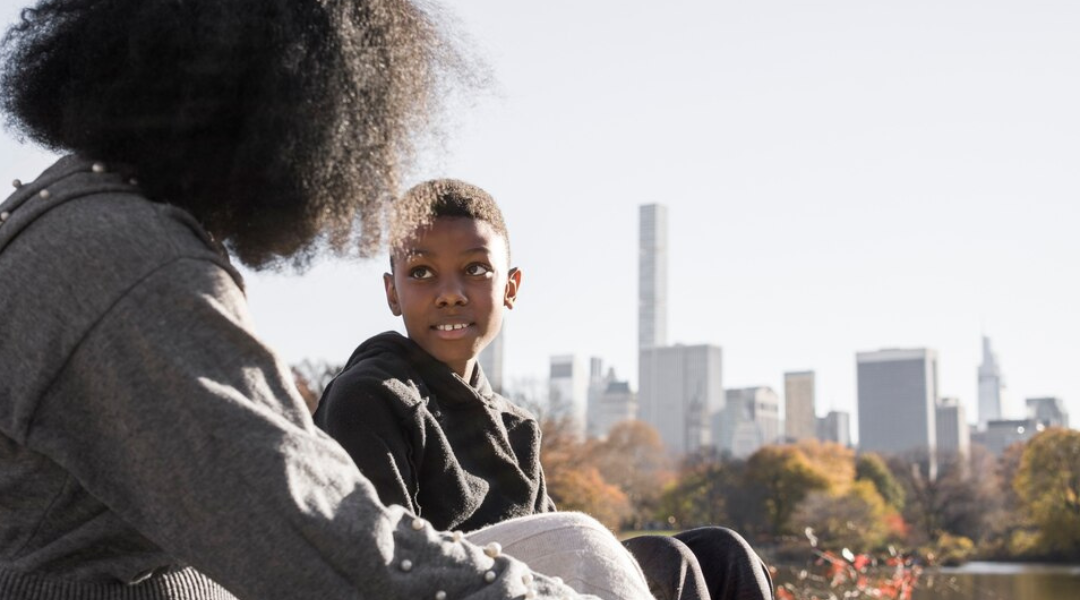 Young teen talking to a trusted adult outside.