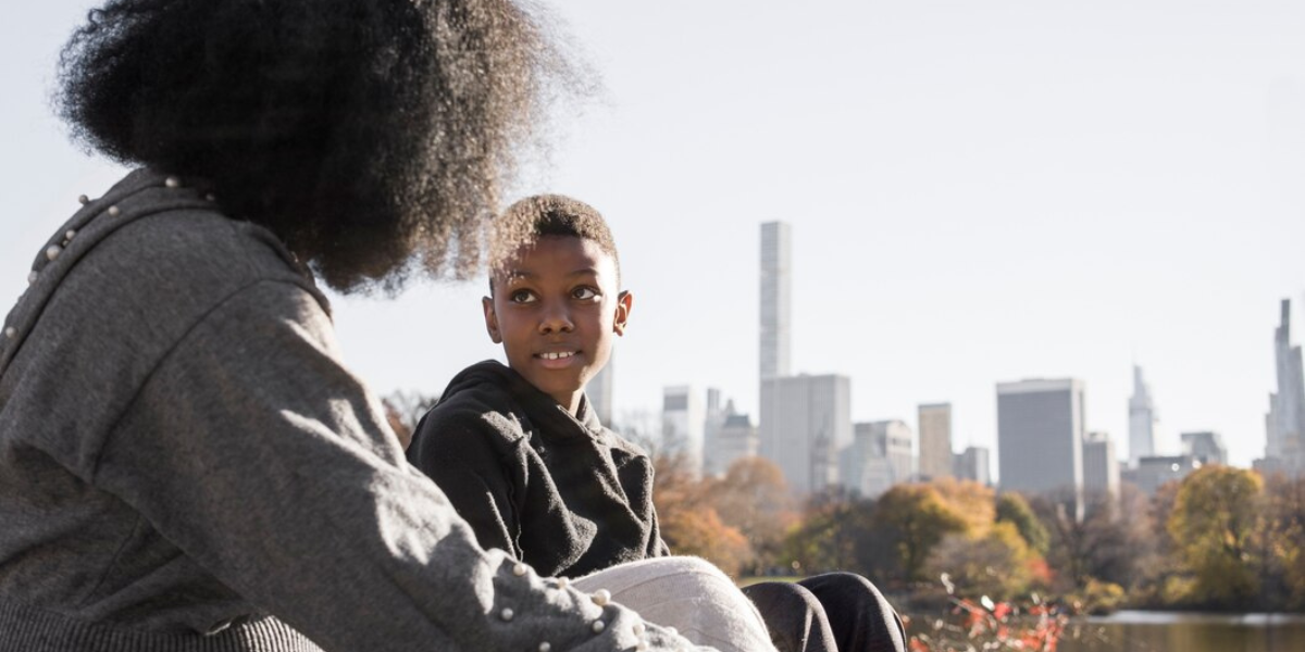 Young teen talking to a trusted adult outside.