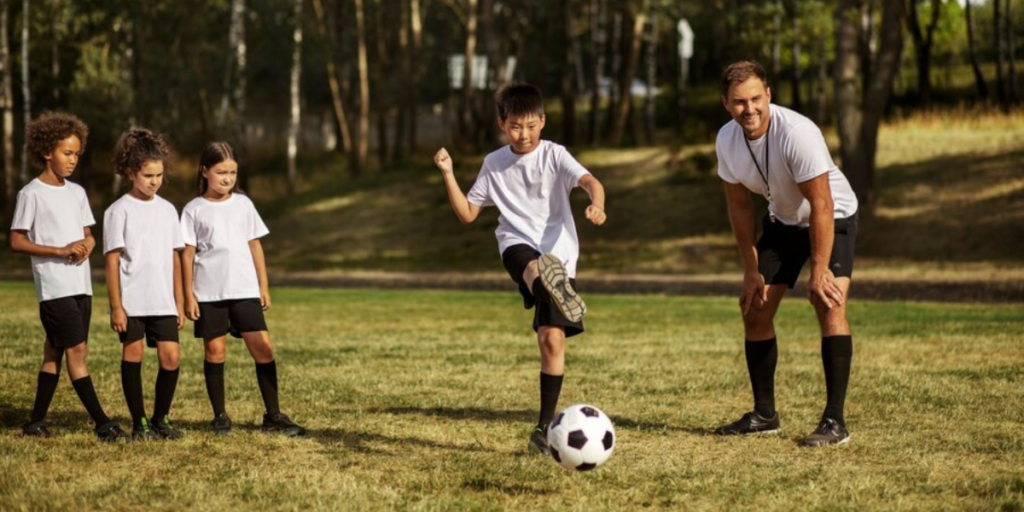 Children playing soccer with a coach.