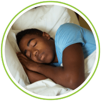 a teenage boy sleeping in bed