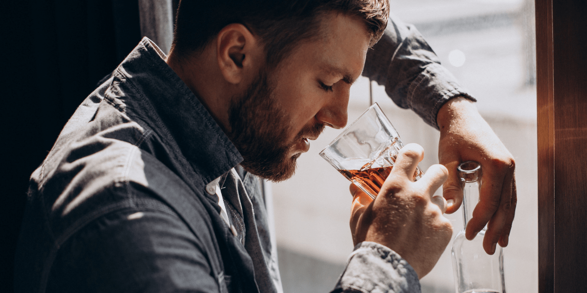 Man drinker depressed with bottle of whiskey